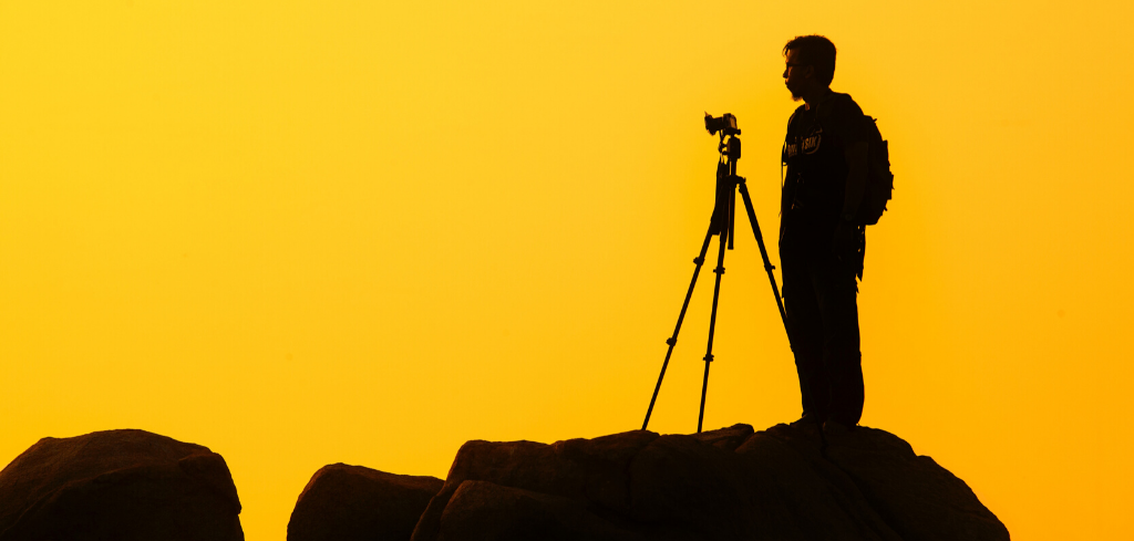 Man standing behind a camera